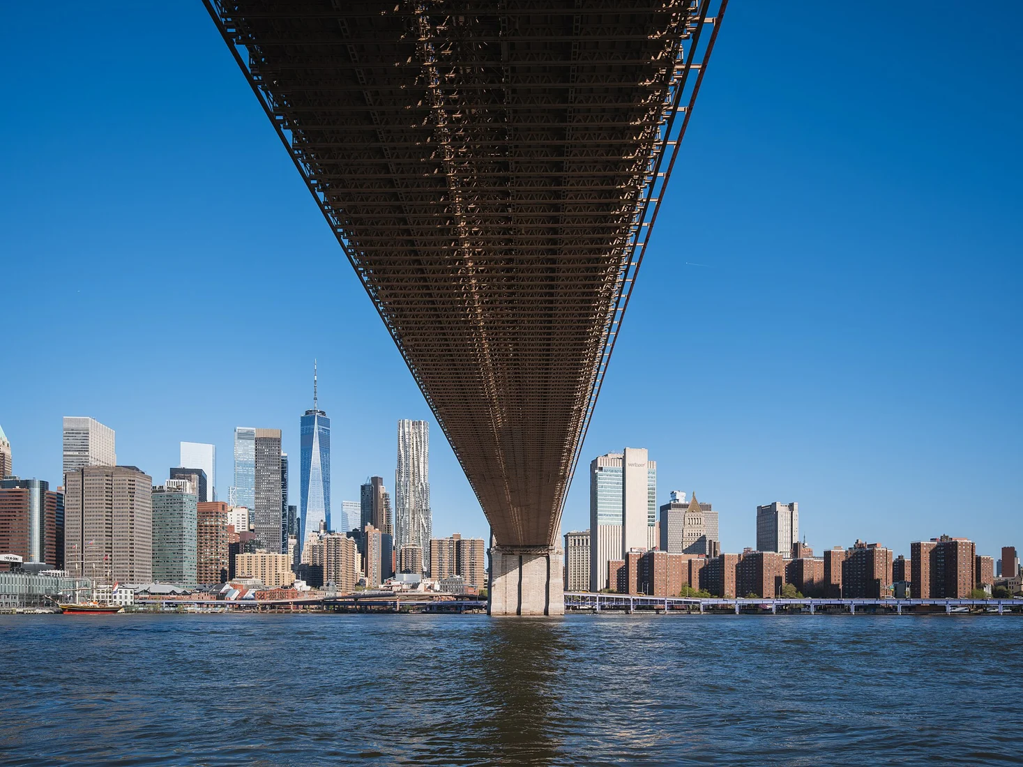 Lower Manhattan skyline from under the Brooklyn Bridge deck, New York City.jpg