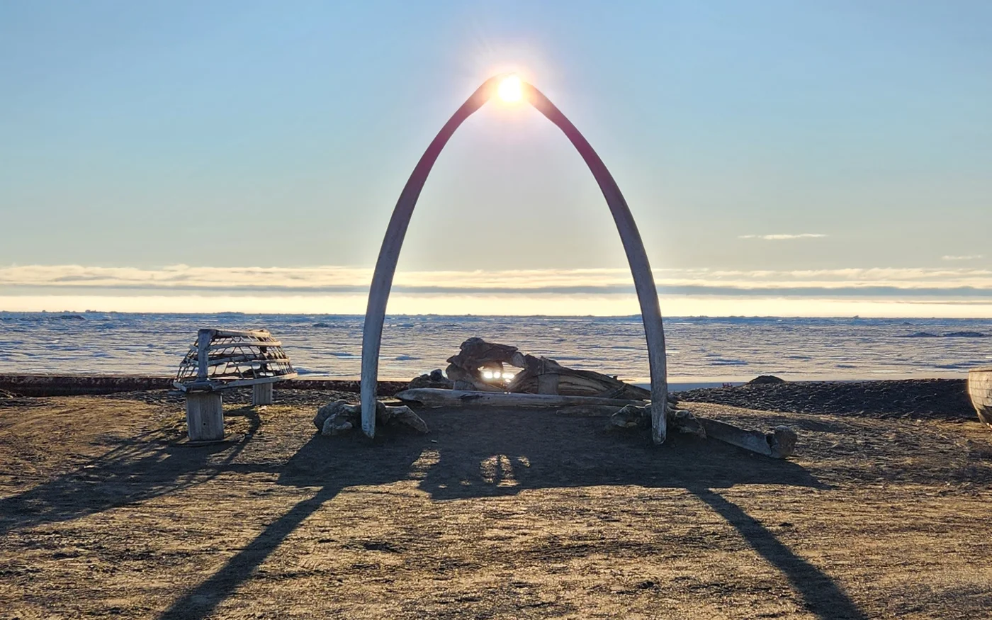 Midnight sun through the whale-bone arch in Utqiaġvik