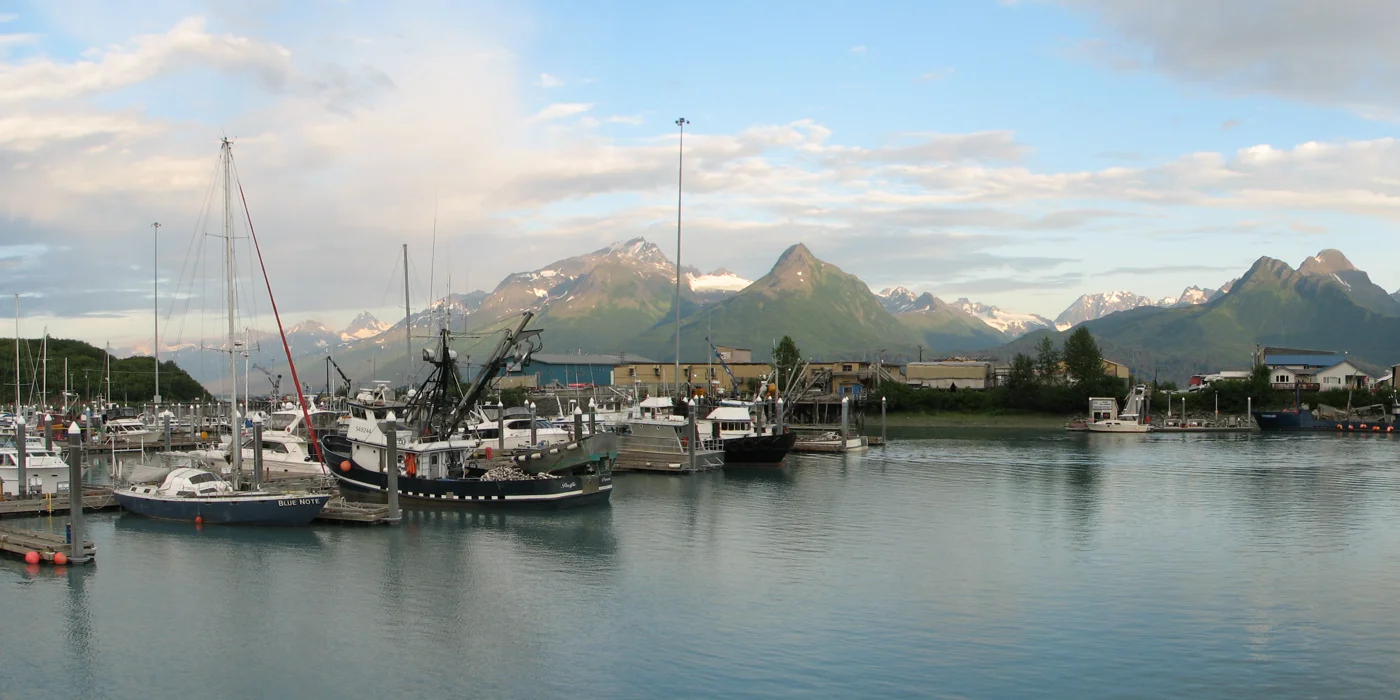 Boats in Valdez harbor beneath the mountains