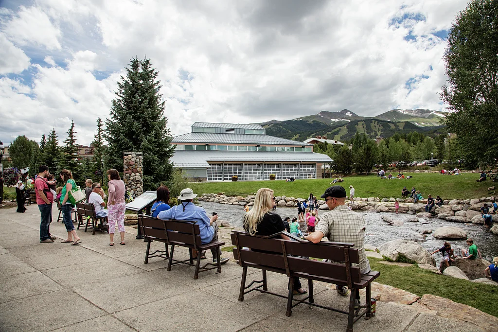 At Breckenridge, Colorado's Blue River Plaza, residents and visitors enjoy the river of the same name near what was once the site of old gold mines. The building in the distance is the Breckenridge Welcome Center