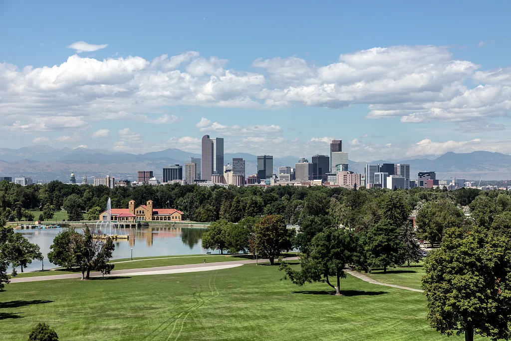 The skyline of Denver, Colorado, across Ferril Lake in City Park, from the Anschutz Family Sky Terrace at the Denver Museum of Nature & Science