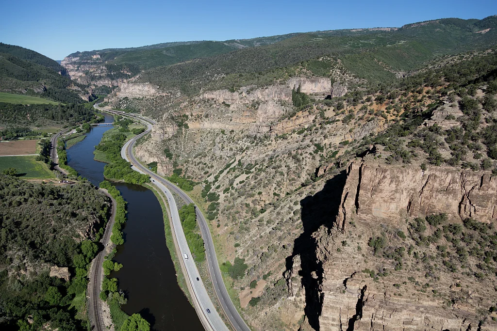 Aerial view of Glenwood Canyon and a portion of the Glenwood Canyon Viaduct, approaching Glenwood Springs, Colorado. The viaduct, one of the United States' engineering marvels, was one of the last pieces of high-speed Interstate Highway 70, between Maryland and Utah, to be completed. It included construction of an upper cantilevered route for westbound lanes, attached to the narrow canyon wall