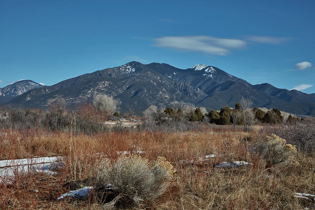 Taos Mountain, known locally as Pueblo Peak, may not look like it towers over the valley outside Taos, New Mexico, once a sleepy southern Sangre de Cristo Mountains town, inhabited by Native Americans for centuries, that has grown into an art colony, filled with museums and dozens of shops, that is now a worldwide tourist attraction
