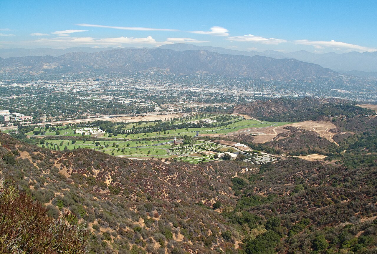 View northeast from Cahuenga Peak in Griffith Park , the green area is Hollywood Hills Forest Lawn Memorial Park . Beyond it are the cities of Burbank and Glendale and the Verdugo 