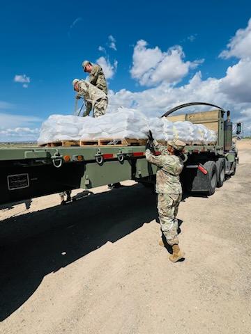 New Mexico National Guard Soldiers of the 1115th Transportation Company move sandbags to support citizens of Ruidoso in the aftermath of fires and flash floods. (Photo courtesy of 